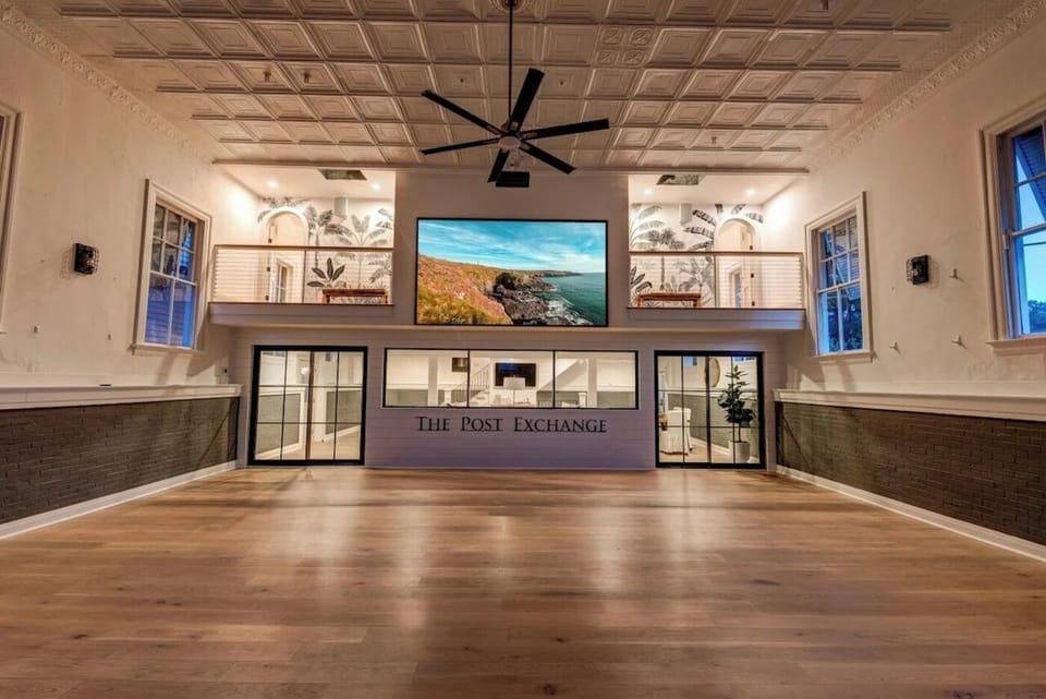 The ballroom cleared for a party, looking toward the mezzanine and The Post Exchange lettering